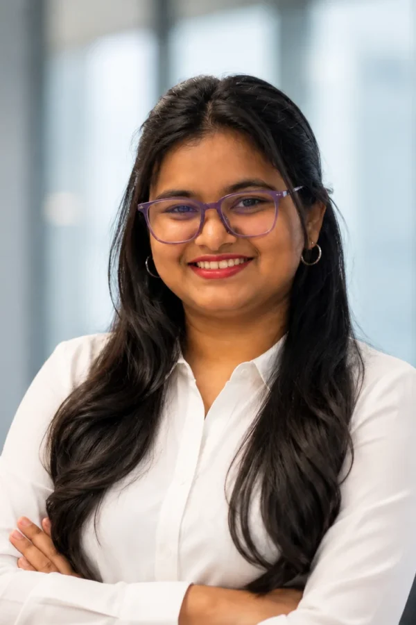 Fefin Martha Areekkal (a woman) standing in a pose of crossed hands, in an office background.